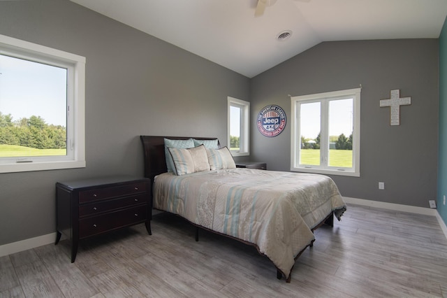 bedroom featuring wood-type flooring, ceiling fan, and vaulted ceiling