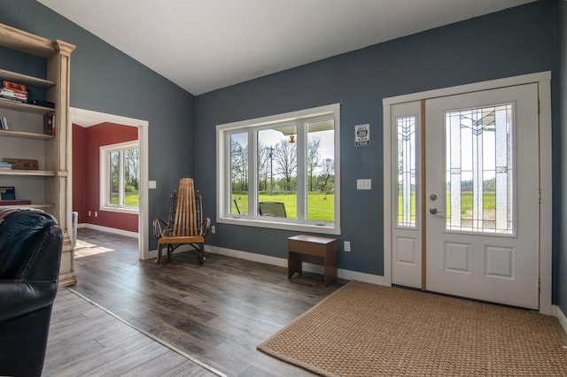 entryway with hardwood / wood-style flooring and vaulted ceiling