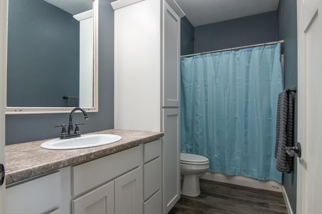 bathroom with toilet, shower / bath combo, wood finished floors, and vanity