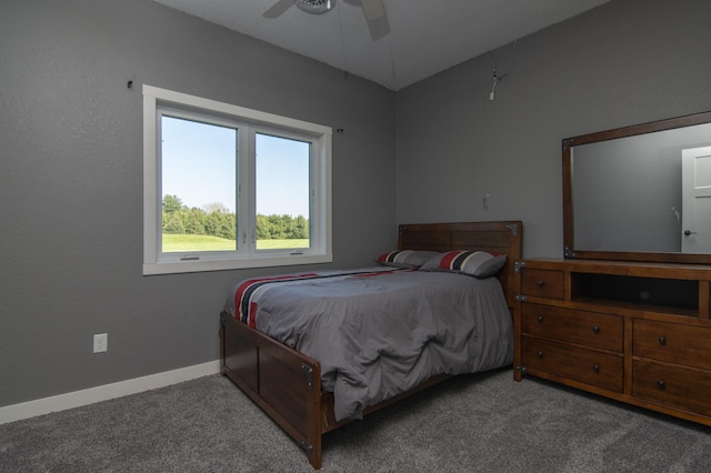 carpeted bedroom featuring baseboards and a ceiling fan