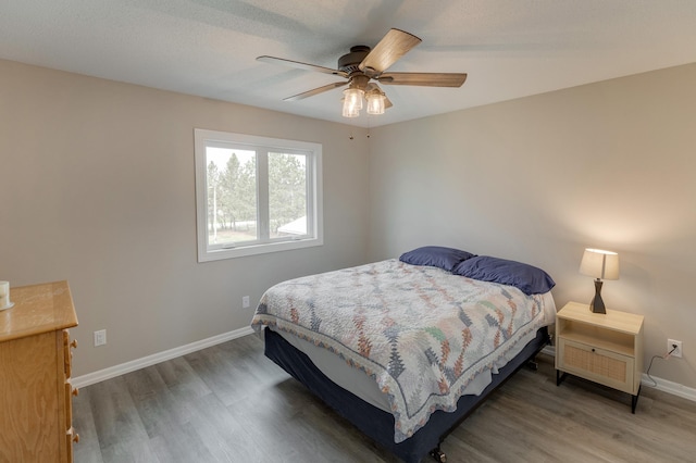 bedroom featuring ceiling fan and hardwood / wood-style flooring