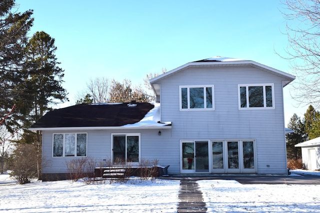 view of snow covered rear of property