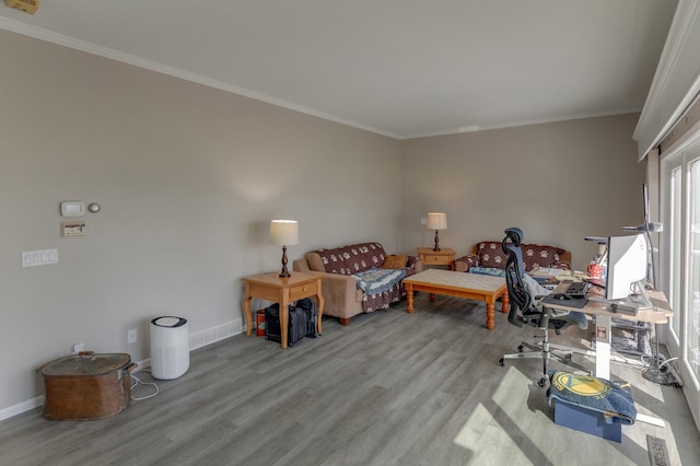 interior space featuring crown molding and light hardwood / wood-style flooring