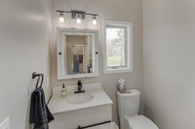 bathroom featuring toilet and vanity