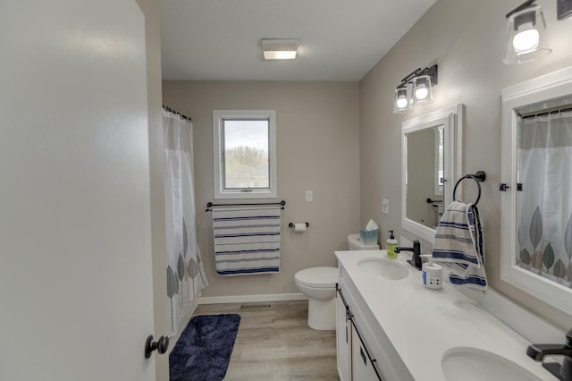 bathroom with toilet, hardwood / wood-style flooring, a shower with curtain, and vanity