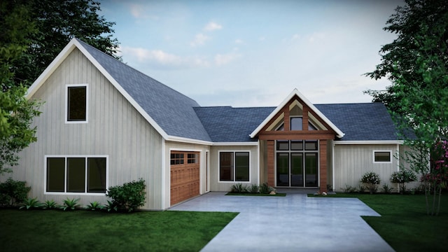 view of front of property featuring a garage and a front lawn