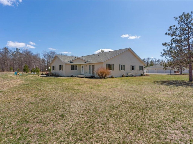 rear view of house featuring a lawn