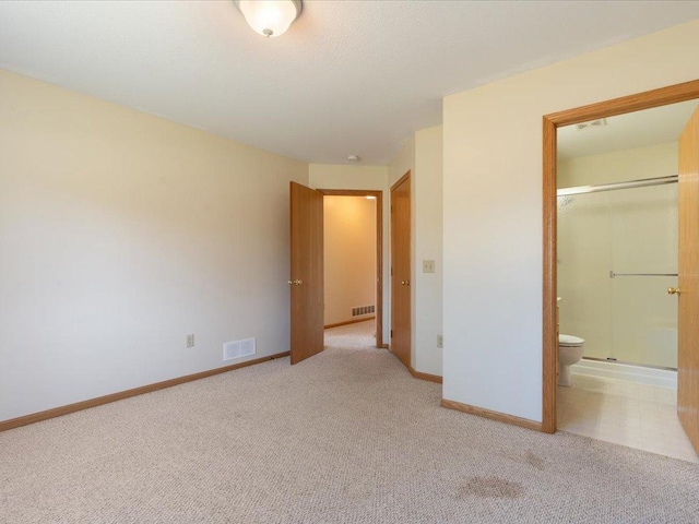 unfurnished bedroom with connected bathroom, carpet flooring, and a closet