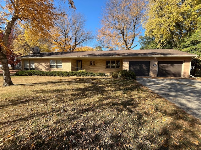 ranch-style house with a front lawn and a garage