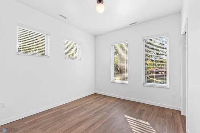 empty room with hardwood / wood-style flooring