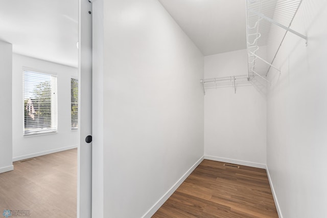 walk in closet featuring wood finished floors and visible vents
