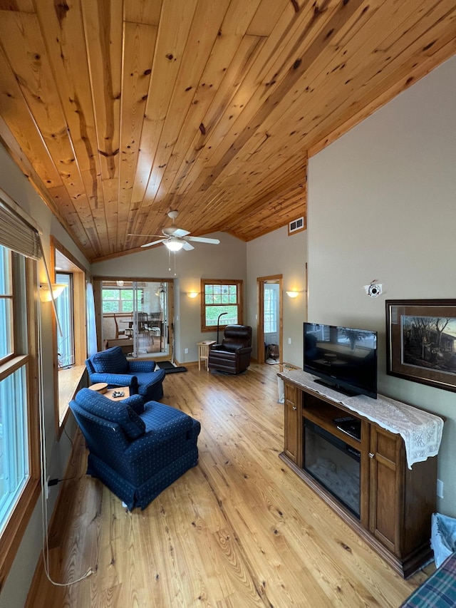 living room featuring vaulted ceiling, ceiling fan, light hardwood / wood-style floors, and wood ceiling