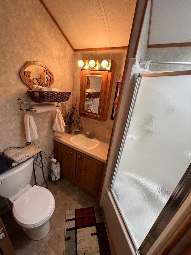 bathroom with a textured ceiling, ornamental molding, tile floors, toilet, and oversized vanity