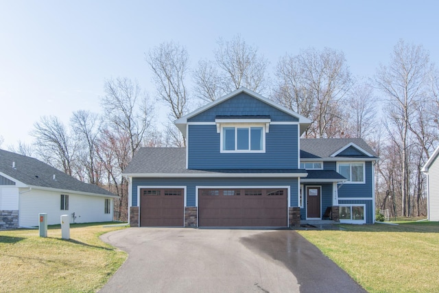 view of front facade with a garage, a front lawn, aphalt driveway, and stone siding