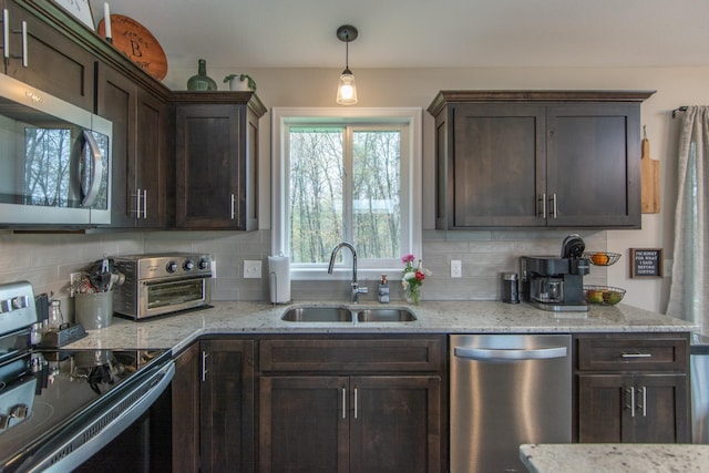 kitchen with a sink, appliances with stainless steel finishes, dark brown cabinetry, and a toaster