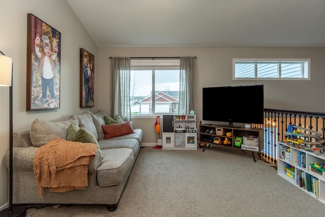 living area with baseboards, carpet, and vaulted ceiling