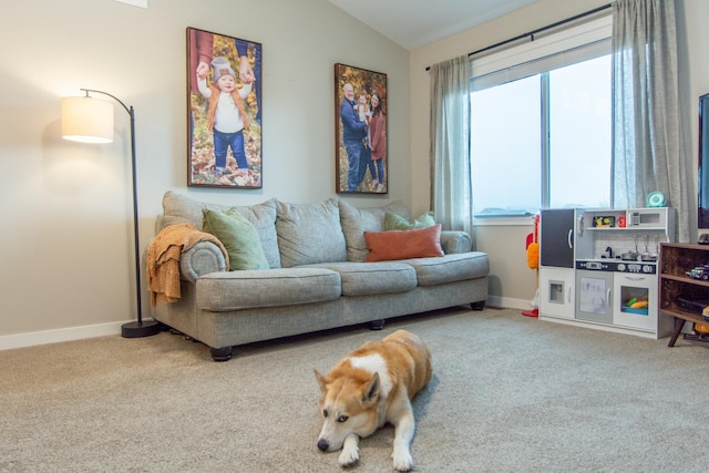 carpeted living room with baseboards and lofted ceiling