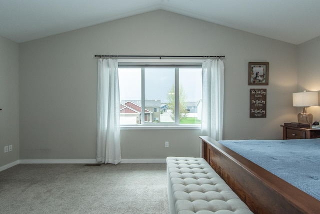 bedroom with carpet floors, baseboards, and vaulted ceiling