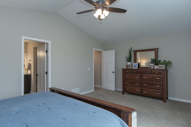 bedroom featuring a ceiling fan, baseboards, carpet flooring, ensuite bath, and vaulted ceiling