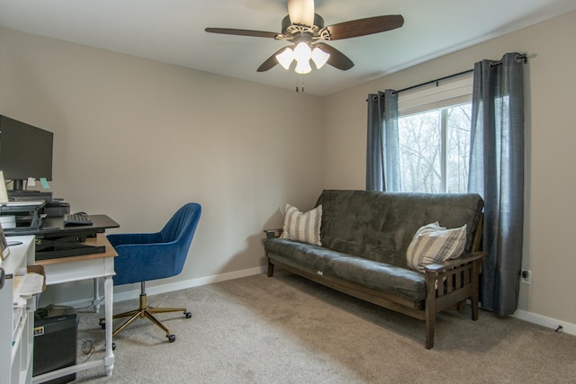 carpeted home office with a ceiling fan and baseboards