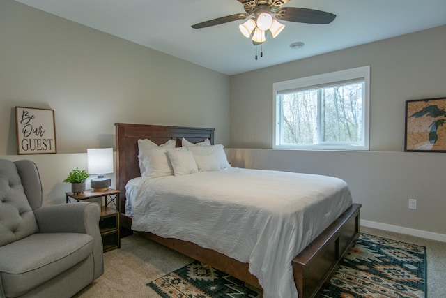 bedroom with baseboards, ceiling fan, and light carpet