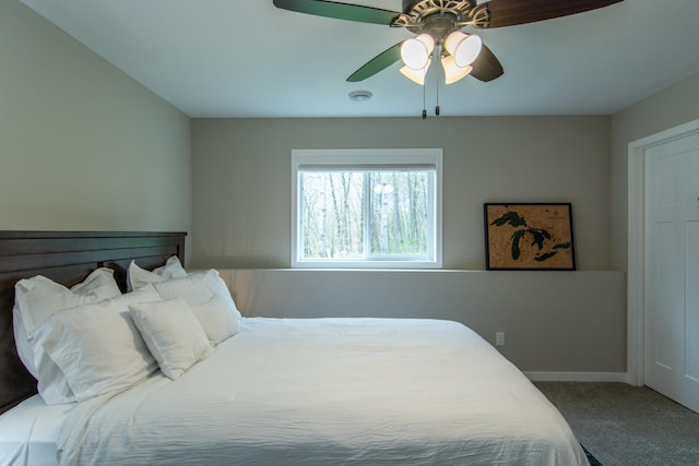 carpeted bedroom with baseboards and ceiling fan