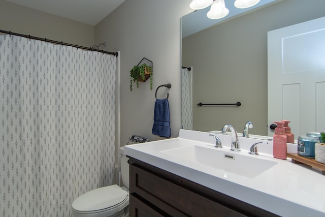 bathroom with vanity, a shower with shower curtain, and toilet
