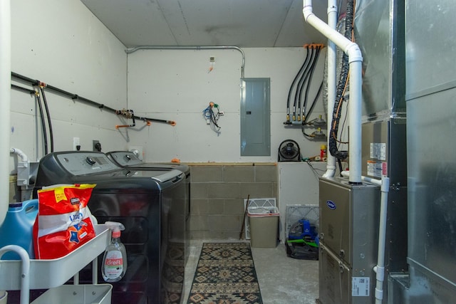 laundry area featuring washer and dryer, laundry area, heating unit, and electric panel
