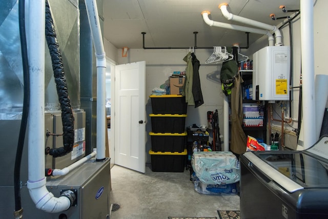 utilities featuring water heater, heating unit, and washer / dryer
