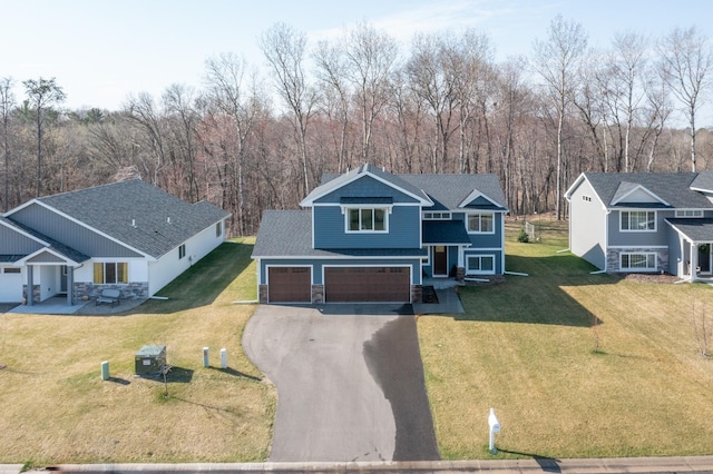 view of front of house with an attached garage, stone siding, a front yard, and aphalt driveway