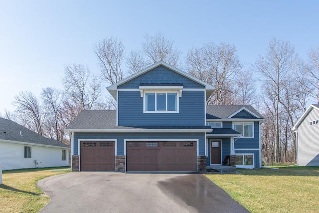 craftsman-style house with a shingled roof, aphalt driveway, stone siding, and a front yard
