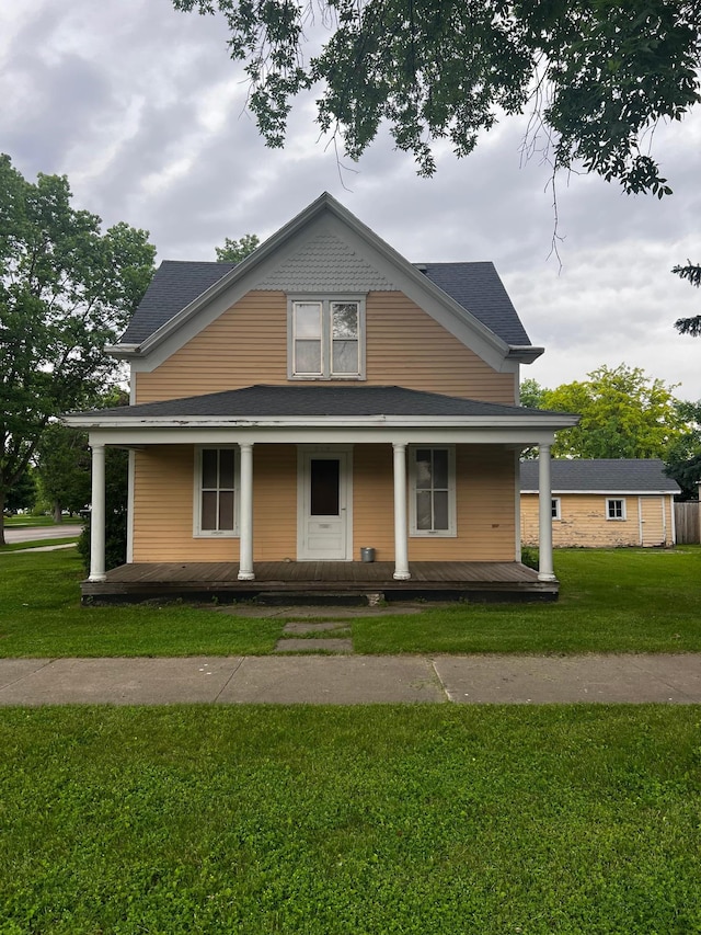 farmhouse with a porch and a front yard