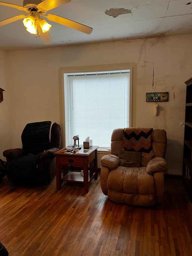 living room with dark hardwood / wood-style floors and ceiling fan