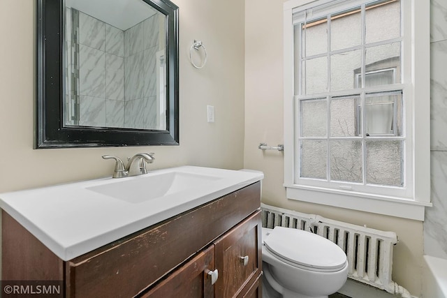 bathroom featuring vanity, toilet, and radiator heating unit