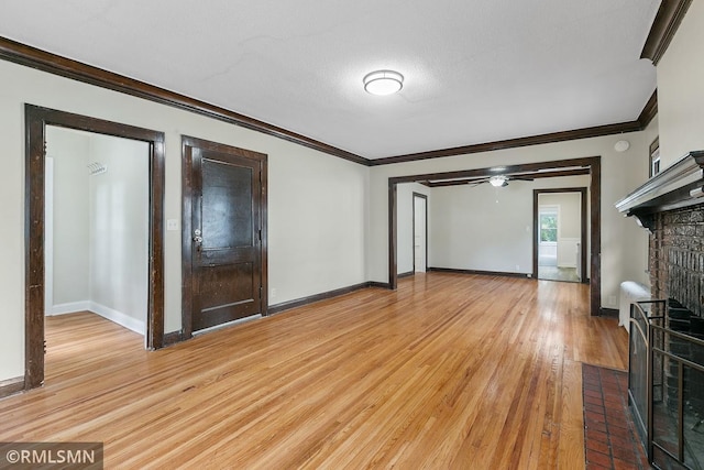 unfurnished living room with ceiling fan, ornamental molding, a textured ceiling, and light hardwood / wood-style floors