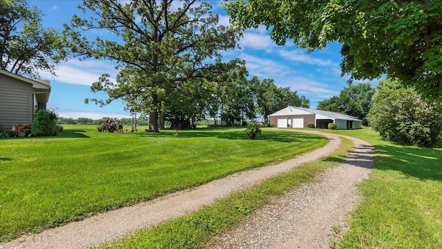 view of yard with a garage and an outdoor structure