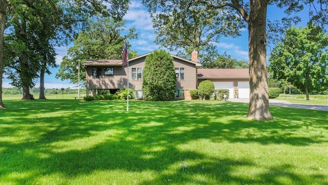 view of front of property with a garage and a front lawn