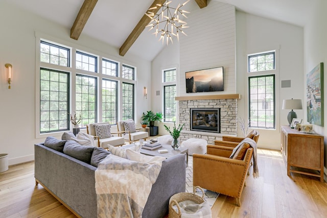 living room with high vaulted ceiling, light hardwood / wood-style flooring, a fireplace, beam ceiling, and a chandelier