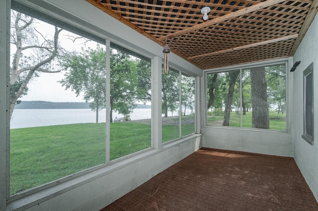 unfurnished sunroom featuring a water view and a healthy amount of sunlight