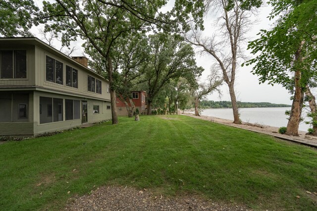 view of yard with a water view and a sunroom