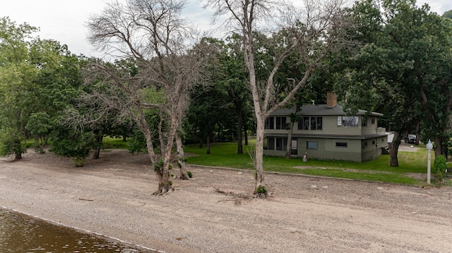 view of front of home with a chimney and a front yard