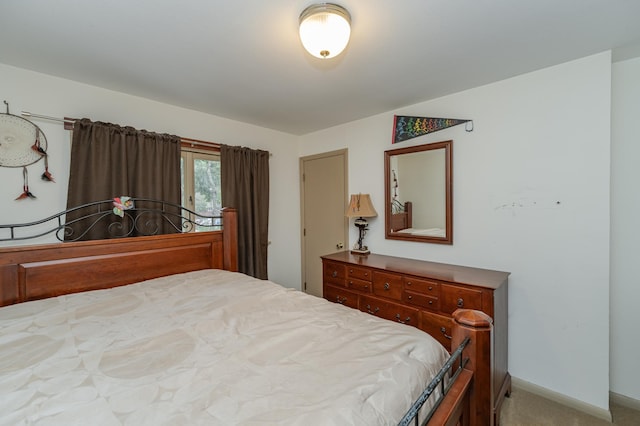 bedroom featuring baseboards and light colored carpet