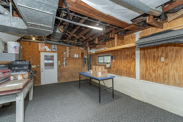 basement featuring wood walls