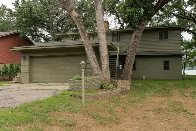 view of front of house with driveway, a chimney, and a front yard