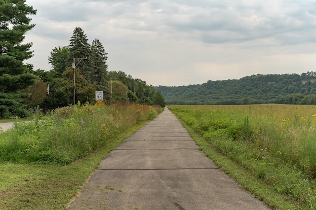 view of road featuring a forest view