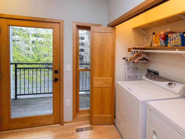 laundry room featuring separate washer and dryer and light wood-type flooring