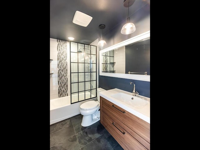 full bathroom featuring tiled shower / bath combo, vanity, and toilet