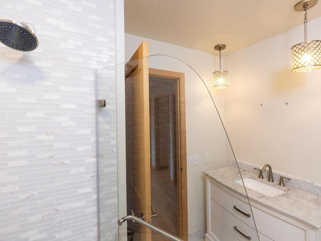 bathroom featuring vanity and a tile shower