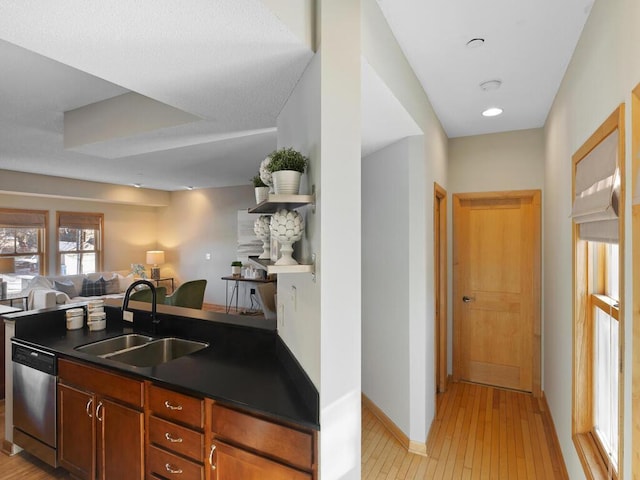 kitchen featuring light wood-type flooring, sink, and dishwasher