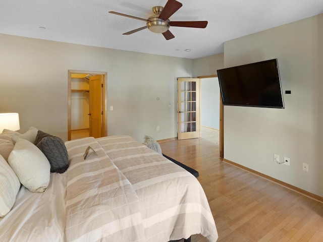 bedroom with ceiling fan and light hardwood / wood-style floors